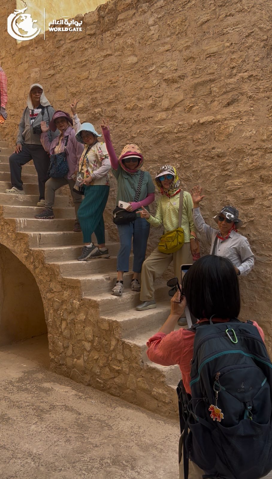 Travellers posing on an ancient stone staircase